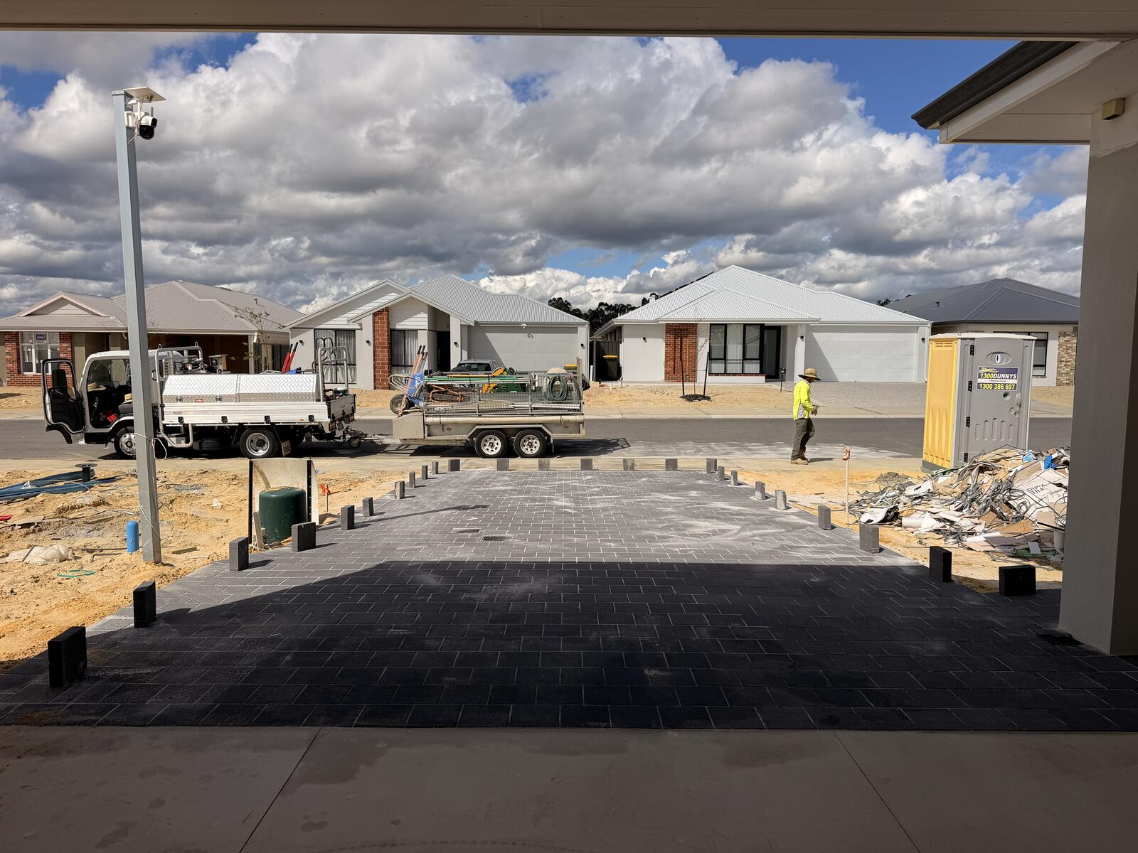 New charcoal paver driveway and carport apron under construction