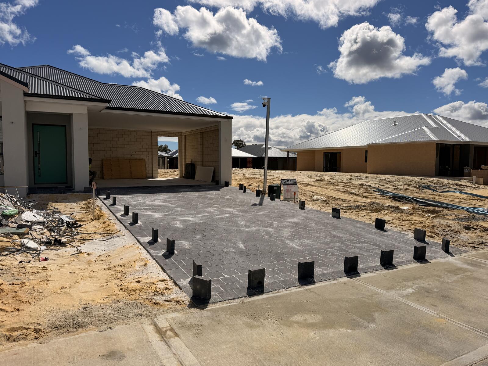 Front yard view of a new charcoal paved driveway