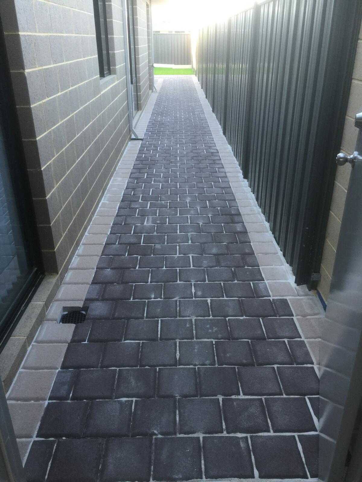 Dark brick paved driveway path