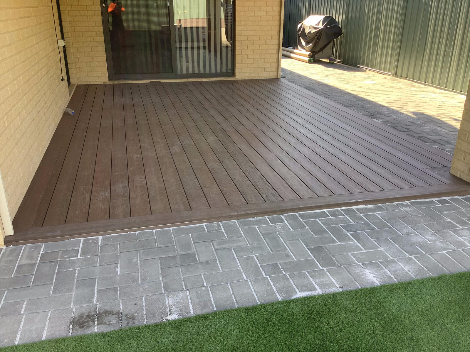 Composite decking and paving under an alfresco area