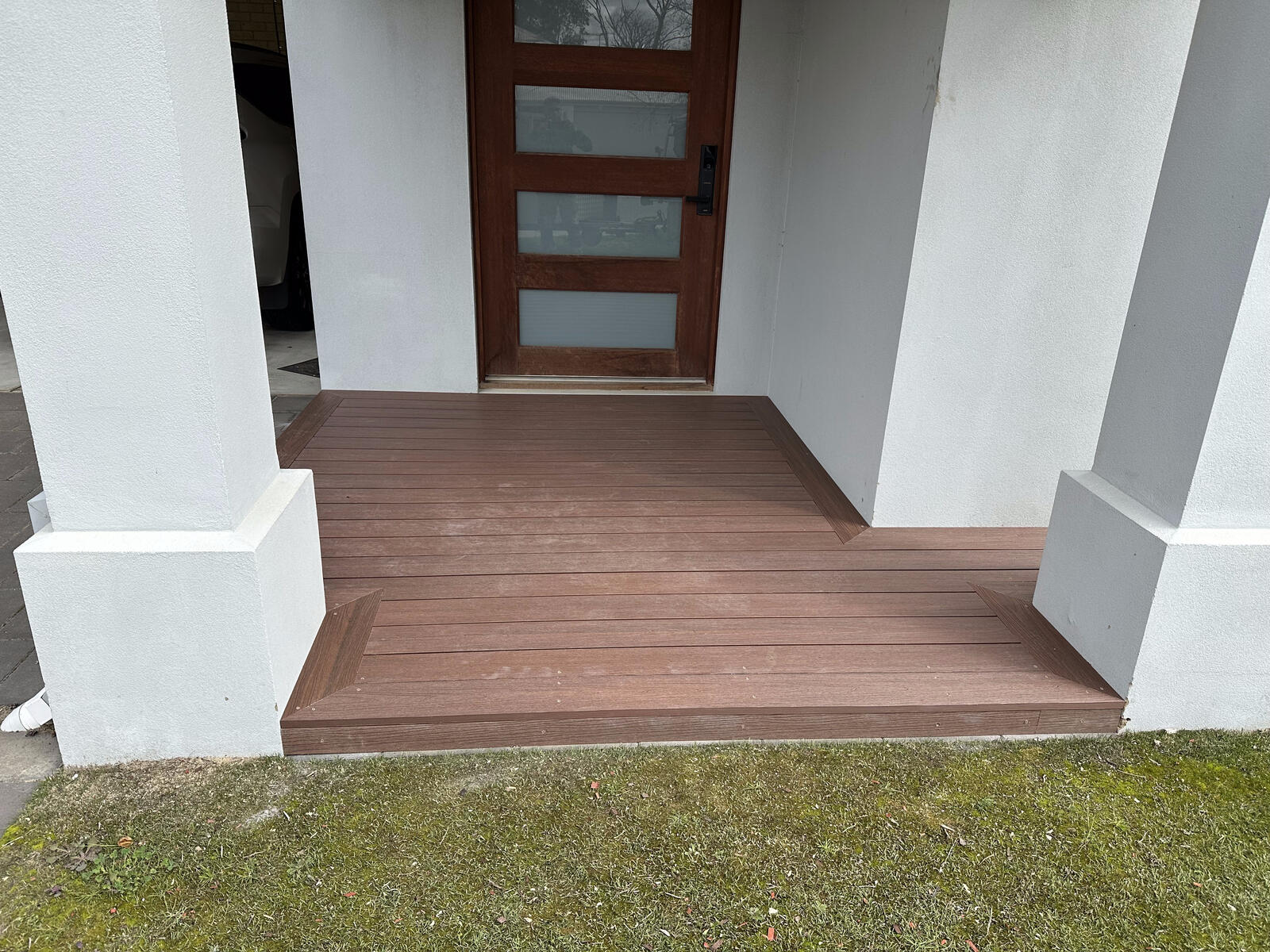 Composite decking at a front entry with a diamond inlay pattern