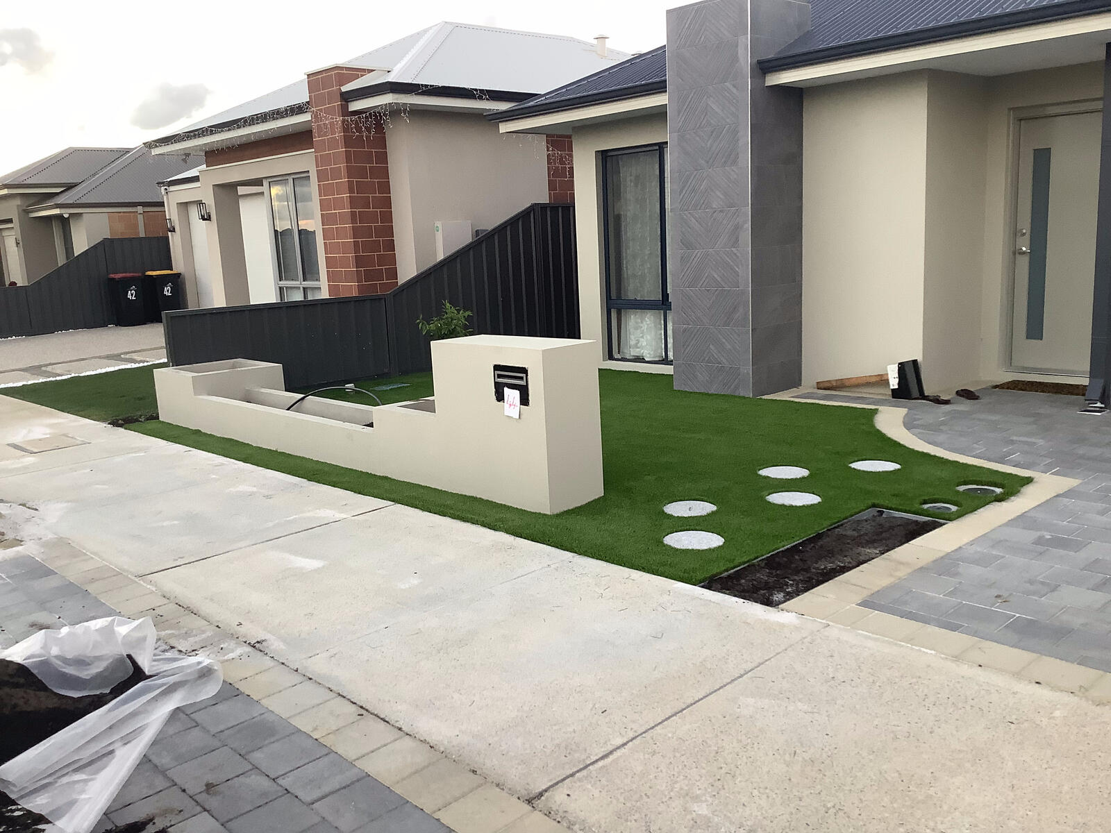 Rendered letterbox wall in a front yard