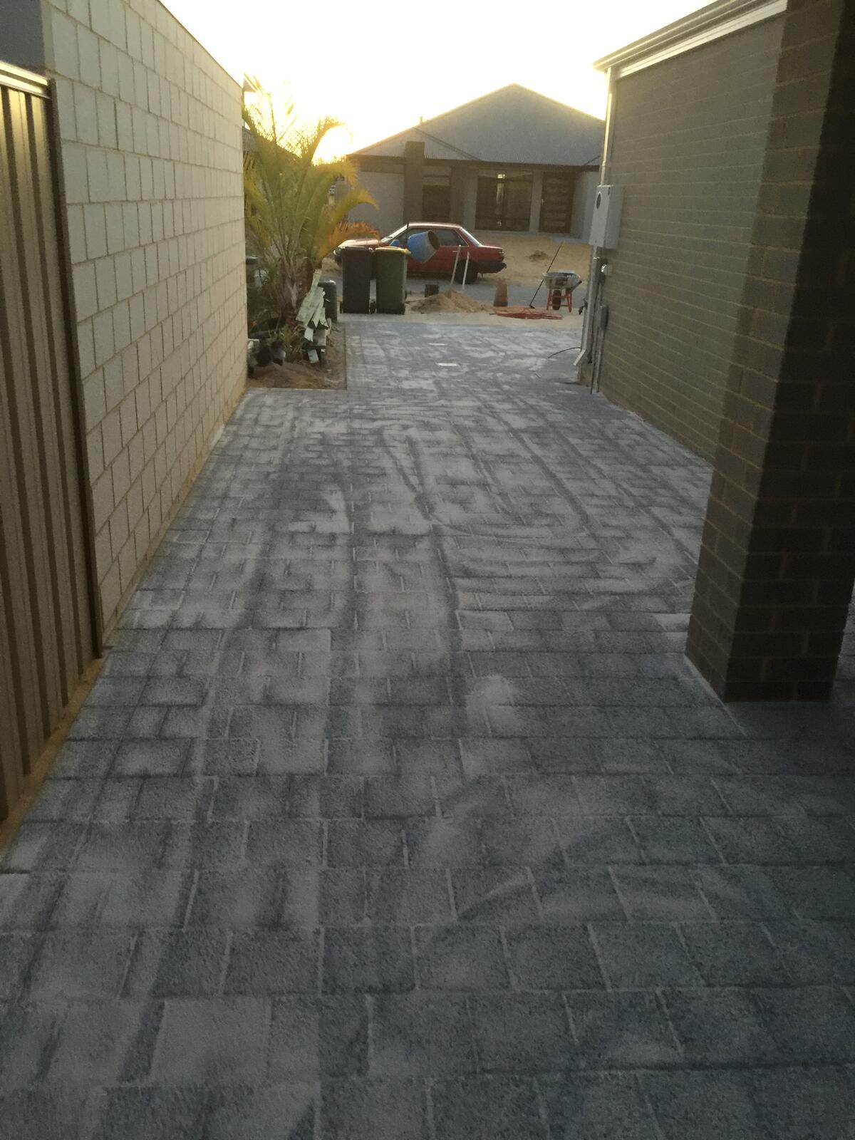 Grey brick paved side path