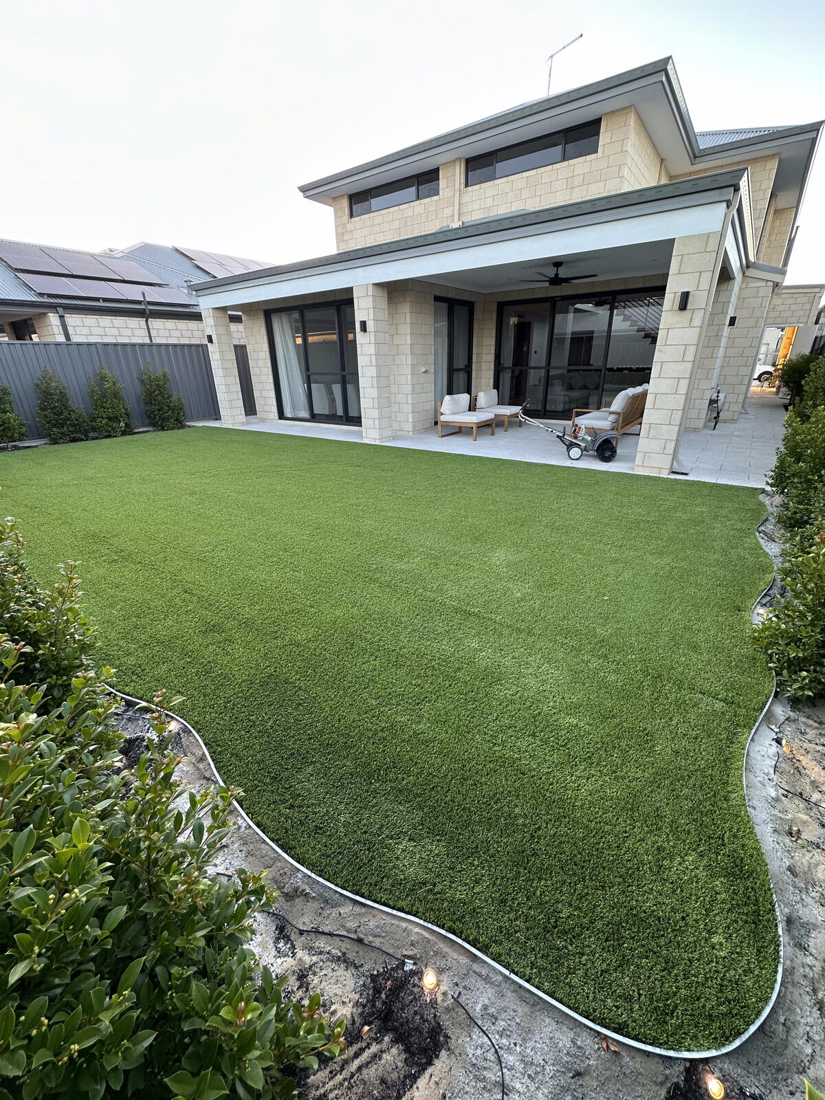 Large artificial turf lawn filling a backyard