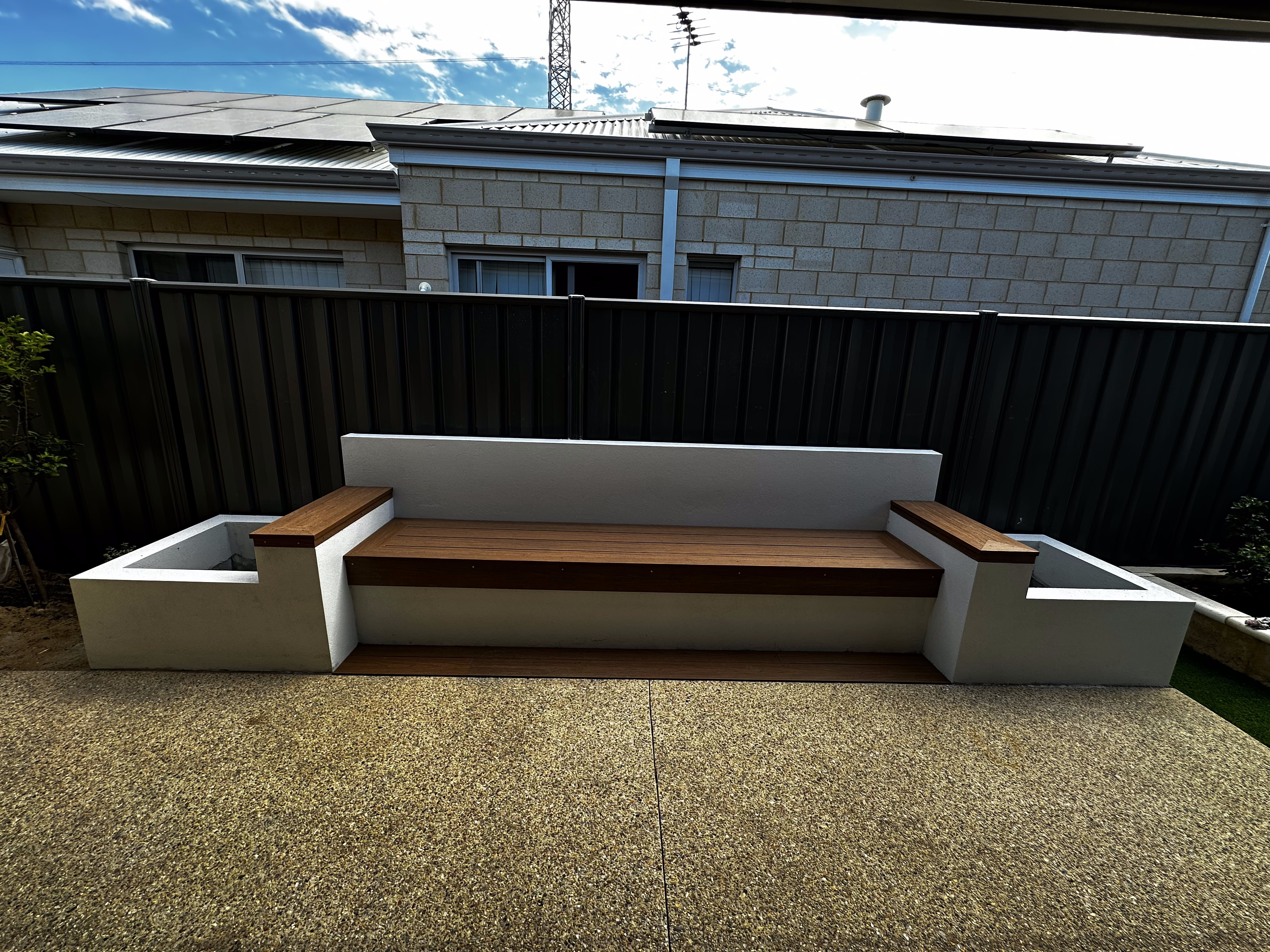 Rendered concrete bench seat with timber inlay