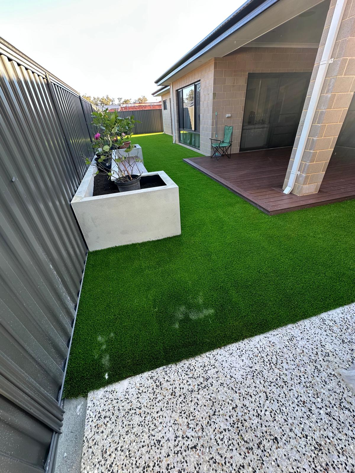 Artificial turf side yard with garden planter