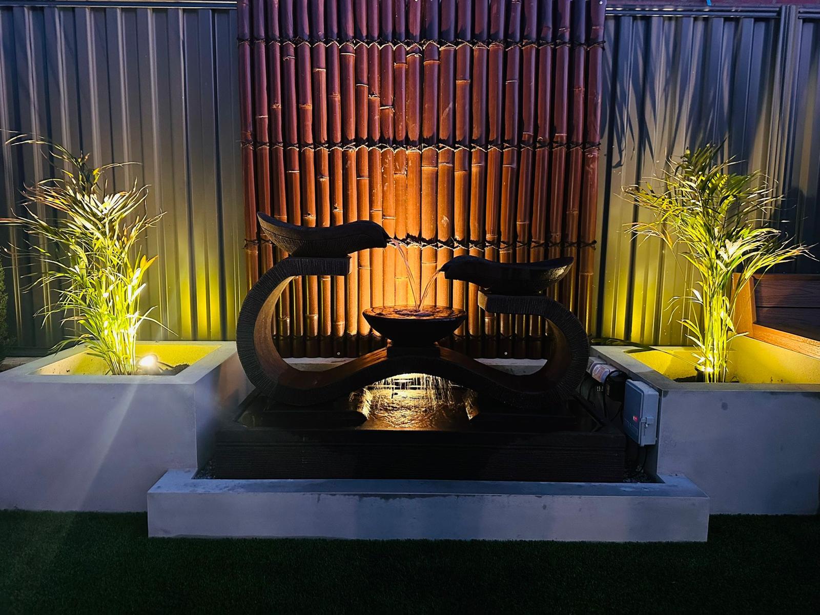 Outdoor water feature lit up at night